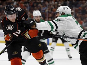 Dallas Stars defenceman Marc Methot, right, checks Anaheim Ducks right wing Corey Perry after Perry shot the puck during the second period of an NHL hockey game in Anaheim, Calif., Wednesday, Feb. 21, 2018.