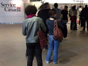 In this file photo, people wait for the Service Canada centre to open on April 2, 2014 in Montreal.