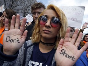 Daisy Hernandez, 22, of Stafford, Va., wrote "Don't Shoot," on her hands during the "March for Our Lives" rally in support of gun control, Saturday, March 24, 2018, in Washington.