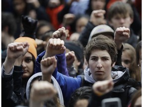 In this Wednesday, March 14, 2018 file photo, demonstrators raise their fists in the air during a student-led march against gun violence at the Civic Center Plaza in San Francisco, one month after the deadly shooting inside a high school in Parkland, Fla.