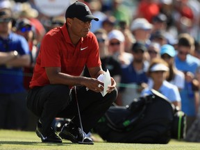 Tiger Woods lines up a putt on the 13th green during the final round at the Arnold Palmer Invitational Presented By MasterCard at Bay Hill Club and Lodge on March 18, 2018