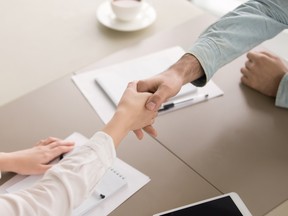 Close up top view of businessman and businesswoman shaking hands