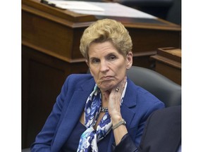 Premier Kathleen Wynne listens to her throne speech being delivered by The Lieutenant Governor of Ontario, The Honourable V. Elizabeth Dowdeswell at Queens Park in Toronto, Ont. on Monday, March 19, 2018.. Stan Behal/Toronto Sun/Postmedia Network
