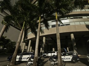 Police cars park outside the main entrance to the Trump Ocean Club International Hotel and Tower, in Panama City, Wednesday, Feb. 28, 2018. (AP Photo/Arnulfo Franco)