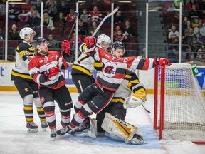 67's captain Travis Barron reaches for the crossbar as he falls into Frontenacs goalie Jeremy Helvig during Saturday's game. Valerie Wutti/Blitzen Photography/OSEG