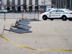 Barricade fencing is knocked over in front of the White House on Pennsylvania Avenue as the region experiences high winds, Friday, March 2, 2018 in Washington. (AP Photo/Andrew Harnik)