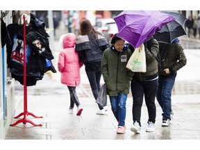 Sunday afternoon Ottawa was just starting to see the effects of the winter storm that has hit other parts of Ontario hard. Pedestrians hustle as they make their way through the market as the rain and freezing rain started to hit the capital Sunday April 15, 2018.