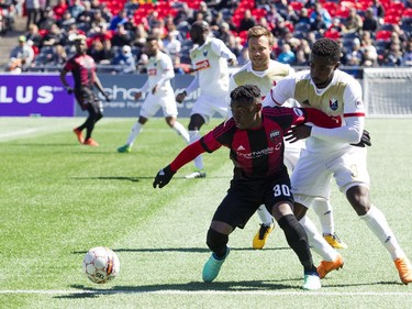 Ottawa Fury FC #30 Adonijah Reid and North Carolina FC #3 Peabo Doue push for the ball during the Furry's home opener Saturday April 21, 2018 at TD Place.