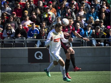 Ottawa Fury FC #9 Carl Haworth and North Carolina FC #33 Aaron Guillen head the ball during the Furry's home opener Saturday April 21, 2018 at TD Place.