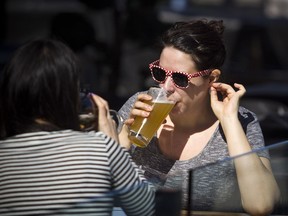 The warm sunshine brought Katie Schultz out to enjoy the patio at JOEY's restaurant at Lansdowne Saturday April 21, 2018. Ashley Fraser/Postmedia