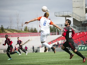Cincinnati FC #6 Kenney Walker heads the ball as Ottawa Fury FC's #80 Cristian Portilla chases Saturday April 28, 2018 at TD Place.