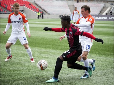 Ottawa Fury FC #30 Adonijah Reid goes for the ball in the first half of the game against Cincinnati FC L-R #16 Richie Ryan and #19 Corben Bone Saturday April 28, 2018 at TD Place.   Ashley Fraser/Postmedia