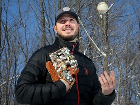 Former major league pitcher, Erik Bedard, picks up the old glove and ball again for some portraits outside of his home in Cumberland Feb. 5, 2018.