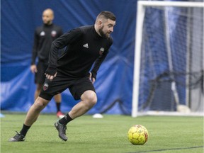 Fury FC defender Colin Falvey dribbles the ball during an indoor practice in March. Most Fury FC workouts so far this year have taken place under a dome.
