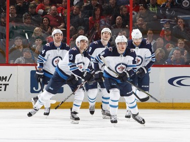 OTTAWA, ON - APRIL 2:  Andrew Copp #9 of the Winnipeg Jets celebrates his first period goal against the Ottawa Senators with teammates Josh Morrissey #44, Brandon Tanev #13, Jacob Trouba #8 and Adam Lowry #17 at Canadian Tire Centre on April 2, 2018 in Ottawa, Ontario, Canada.