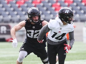 Keith Sanscartier (left) battle against RJ Shelton at Ottawa Redblacks mini-camp on Tuesday.
(JEAN LEVAC/Postmedia Network)