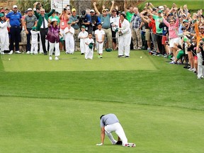 Tony Finau falls after rolling his ankle while celebrating a hole-in-one on the seventh hole during the Masters Par 3 Contest on Wednesday.