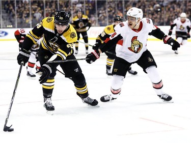 Mark Borowiecki of the Senators defends Tim Schaller of the Bruins during the first period.