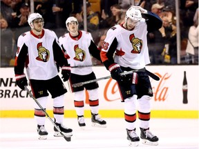 The Senators' Mark Borowiecki, left, Thomas Chabot, middle, and Magnus Paajarvi return to the bench after David Pastrnak of the Bruins scored a goal during the second period of Saturday's game in Boston.