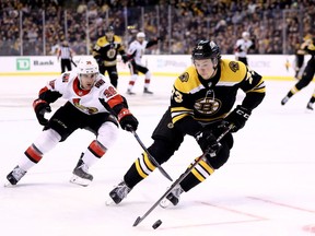 Senators forward Colin White pursues Bruins defenceman Charlie McAvoy during the second period of Saturday's game in Boston.