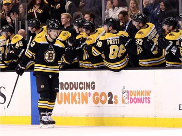 Danton Heinen of the Bruins celebrates with teammates after scoring a goal against the Senators during the second period.