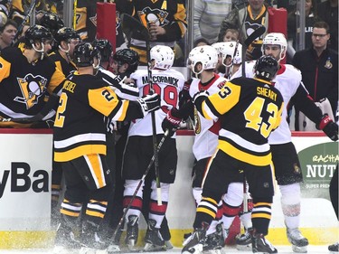 Senators and Penguins players engage in some post-whistle pushing and shoving during the first period of play.