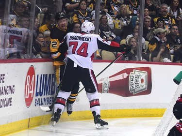 Mark Borowiecki of the Senators checks Patric Hornqvist of the Penguins into the boards during the third period.