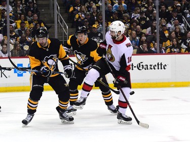 Tom Pyatt of the Senators tries to avoid the puck as it's shot towards the Penguins net in the third period.