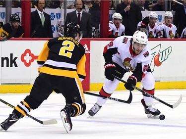 Mike Hoffman of the Senators skates with the puck against Chad Ruhwedel of the Penguins in the third period of the game at Pittsburgh on Friday.