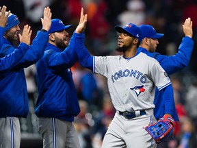 Teoscar Hernandez celebrates with teammates after the Blue Jays defeated the Indians at Progressive Field on Friday night.