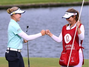 Brooke Henderson of Smiths Falls celebrates a four-shot victory with her her caddie and sister Brittany Henderson in Hawaii on Saturday.
