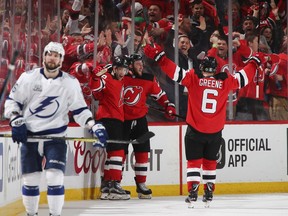 Stefan Noesen #23 of the New Jersey Devils (c) celebrates his game wining goal along with Taylor Hall #9 and Andy Greene #6 at 12:55 of the third period against the Tampa Bay Lightning in Game Three of the Eastern Conference First Round during the 2018 NHL Stanley Cup Playoffs at the Prudential Center on April 16, 2018 in Newark, New Jersey. The Devils defeated the Lightning 5-2.