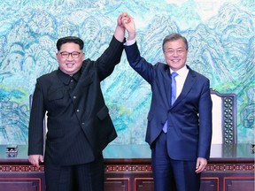 PANMUNJOM, SOUTH KOREA - APRIL 27:  North Korean leader Kim Jong Un (L) and South Korean President Moon Jae-in (R) pose for photographs after signing the Panmunjom Declaration for Peace, Prosperity and Unification of the Korean Peninsula during the Inter-Korean Summit at the Peace House on April 27, 2018 in Panmunjom, South Korea. Kim and Moon meet at the border today for the third-ever Inter-Korean summit talks after the 1945 division of the peninsula, and first since 2007 between then President Roh Moo-hyun of South Korea and Leader Kim Jong-il of North Korea.