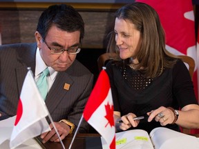 Canada's Minister of Foreign Affairs Chrystia Freeland and Japanese Foreign Minister Taro Kono sign a Cross-Servicing agreement in Toronto, Ontario, on Saturday, April 21, 2018.