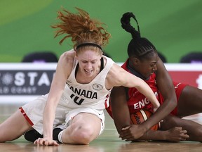 Canada's Catherine Traer and England's Melita Emanuel-Carr scramble for the ball during a women's semifinal basketball game on Friday.