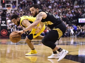 Raptors guard Fred VanVleet, right, strips the ball from Pacers guard Cory Joseph during the first half of action on Friday night.