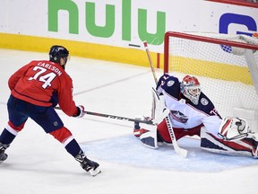 Columbus Blue Jackets goaltender Sergei Bobrovsky (72), of Russia, reaches for the puck in front of Washington Capitals defenseman John Carlson (74) during overtime of Game 5 of an NHL first-round hockey playoff series, Saturday, April 21, 2018, in Washington. The Capitals won 4-3.