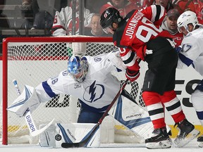 Andrei Vasilevskiy of the Tampa Bay Lightning makes the save as Marcus Johansson of the New Jersey Devils looks on at the Prudential Center on April 18, 2018 in Newark, New Jersey. (Bruce Bennett/Getty Images)