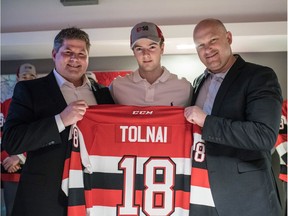 Cameron Tolnai, middle, poses with 67's general manager James Boyd, left, and head coach André Tourigny before development camp on-ice sessions began at the University of Ottawa arena. Chris Hofley photo