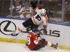 Flyers winger Michael Raffl and Panthers defenceman Mike Matheson (19) battle for the puck during the third period of a game on March 4.