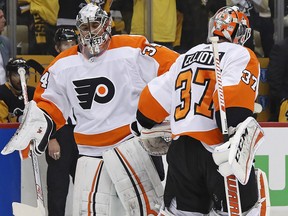Philadelphia Flyers goaltender Brian Elliott (37) heads for the bench after being replaced by Petr Mrazek (34) during Game 1 against the Pittsburgh Penguins in Pittsburgh, Wednesday, April 11, 2018. (AP Photo/Gene J. Puskar)