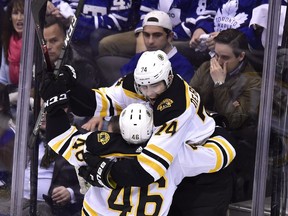 Boston Bruins left-winger Jake DeBrusk (74) celebrates his goal on Toronto Maple Leafs goaltender Frederik Andersen (31) with teammate David Krejci (46) during the third period in Toronto on Thursday, April 19, 2018.