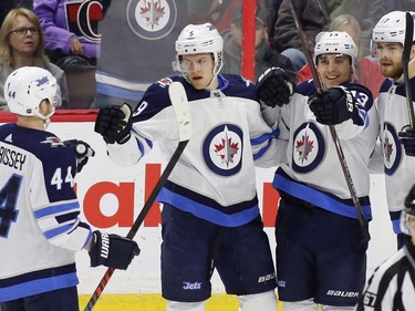 Winnipeg Jets Andrew Copp (9) celebrates his goal with teammates Josh Morrissey (44), Brandon Tanev (13) and Adam Lowry (17) during first period NHL hockey action against the Ottawa Senators at the Canadian Tire Centre in Ottawa on Monday, April 2, 2018.