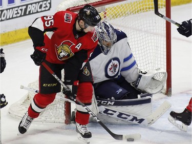 Ottawa Senators Matt Duchene (95) tries to get the puck past Winnipeg Jets goaltender Connor Hellebuyck (37) during first period NHL hockey action at the Canadian Tire Centre in Ottawa on Monday, April 2, 2018.