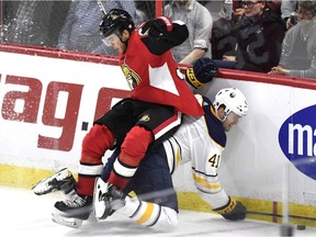 Senators winger Magnus Paajarvi, top, and the Sabres' Justin Falk crash into the boards during the second period of a game in Ottawa in March.