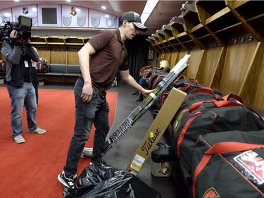 Ottawa Senators right winger Alex Burrows places his hockey sticks with his belongings in the locker room after speaking to reporters during the team's season wrap up in Ottawa, Monday April 9, 2018.