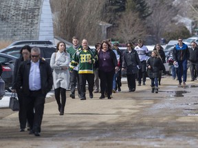 Community members enter memorial service for Logan Schatz, captain of the Humboldt Broncos, who one of 16 people killed in a bus crash on April 6th 2018, in Allan, Sask. Sunday, April 15, 2018.