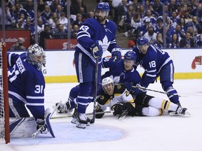 Boston Bruins centre Riley Nash is tackled by Toronto Maple Leafs defenceman Jake Gardiner as Andreas Johnsson, Nazem Kadri and goalie Frederik Andersen react during during Game 6 at the Air Canada Centre on April 23, 2018