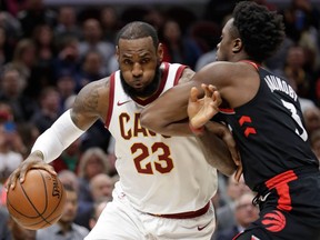 Cleveland Cavaliers' LeBron James drives past Toronto Raptors' OG Anunoby during the first half of an NBA game on April 3, 2018