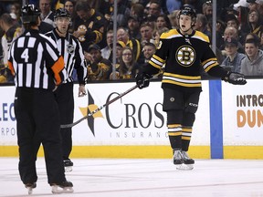 Boston Bruins defenceman Charlie McAvoy argues with referee Wes McCauley (4) after being called for a penalty in Boston Sunday, April 8, 2018. (AP Photo/Winslow Townson)